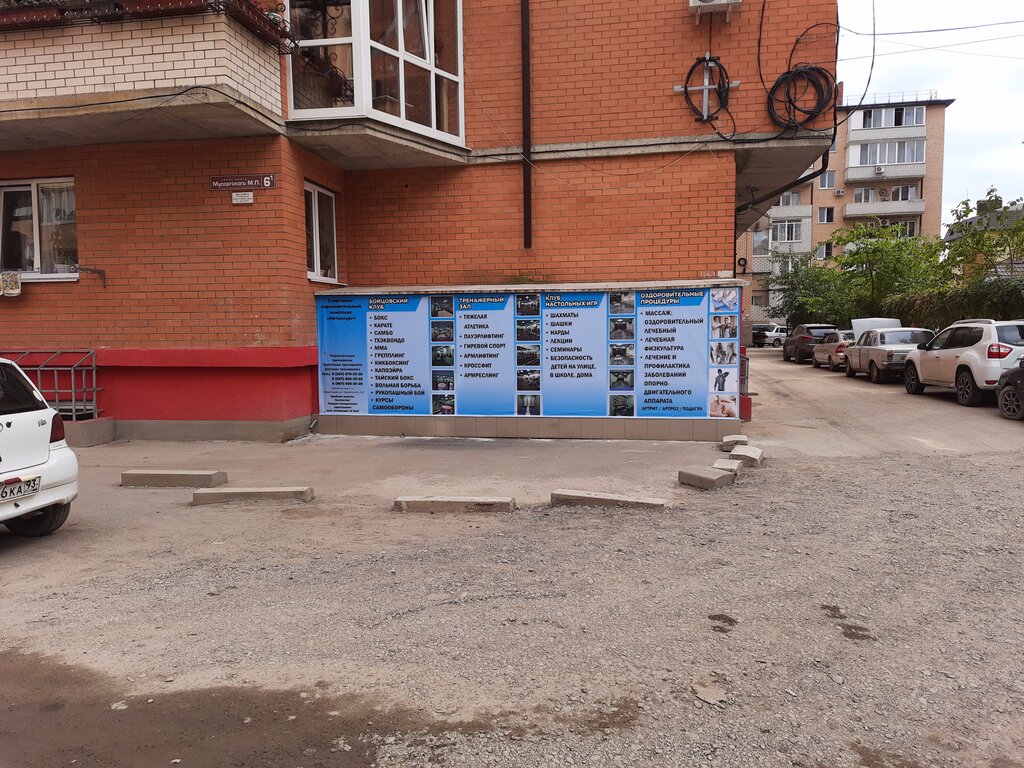 Экстерьер здания спорткомплекса Металлург с баннером о бойцовском и тренажёрном залах